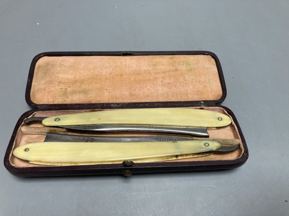 A silver-mounted Meerschaum pipe and two cut-throat razors, all cased